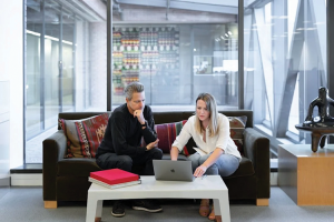 man and woman looking at laptop showing brand design firm